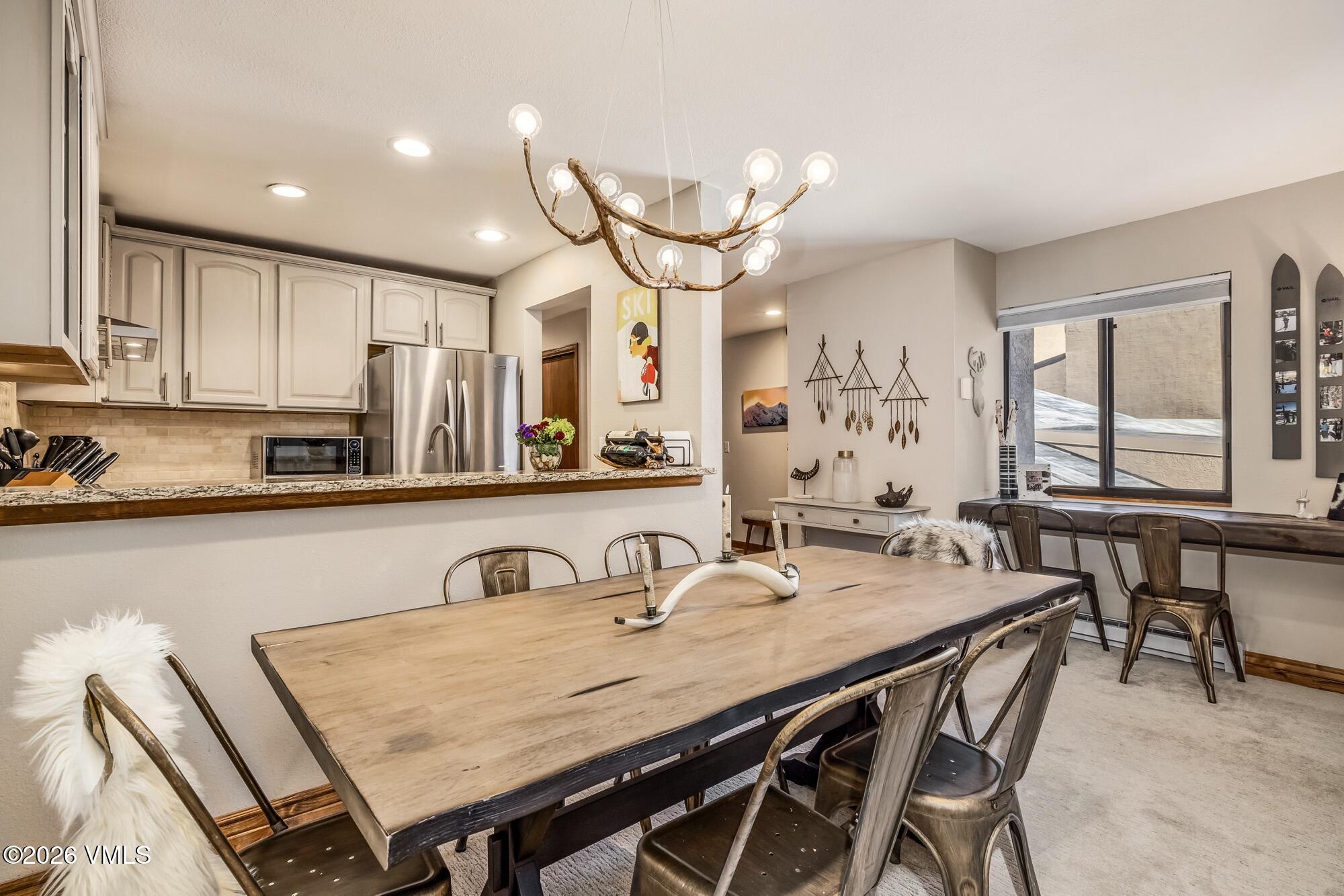137 Benchmark Road, Unit 513 Avon, CO 81620 - Photo 7 of 31 a view of a a dining table chairs and kitchen