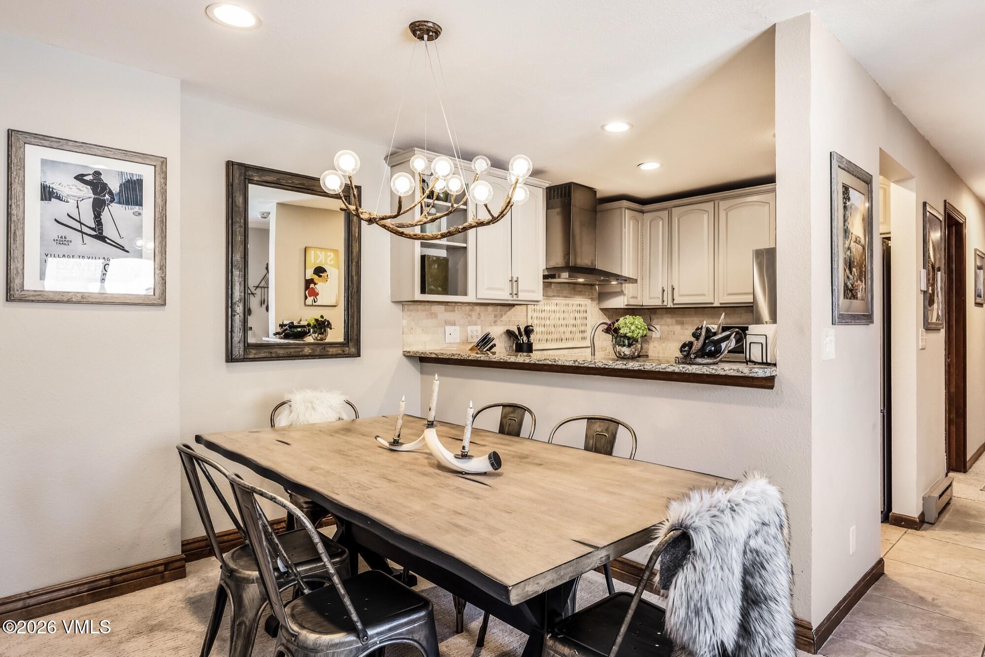 137 Benchmark Road, Unit 513 Avon, CO 81620 - Photo 8 of 31 a view of kitchen with granite countertop a table and chairs in it
