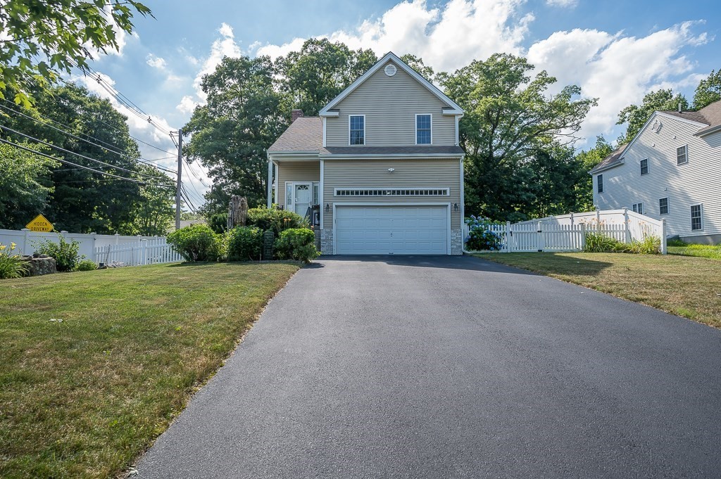 2 Gerry Drive, Unit 2 Hudson, MA 01749 - Photo 1 of 41 a front view of a house with a yard and garage