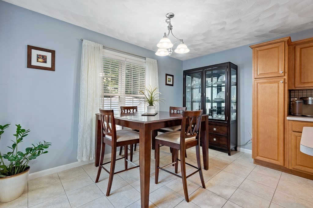 2 Gerry Drive, Unit 2 Hudson, MA 01749 - Photo 12 of 41 a view of a dining room with furniture and chandelier
