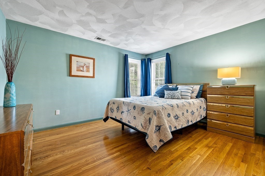 2 Gerry Drive, Unit 2 Hudson, MA 01749 - Photo 16 of 41 a bedroom with a bed and a night stand