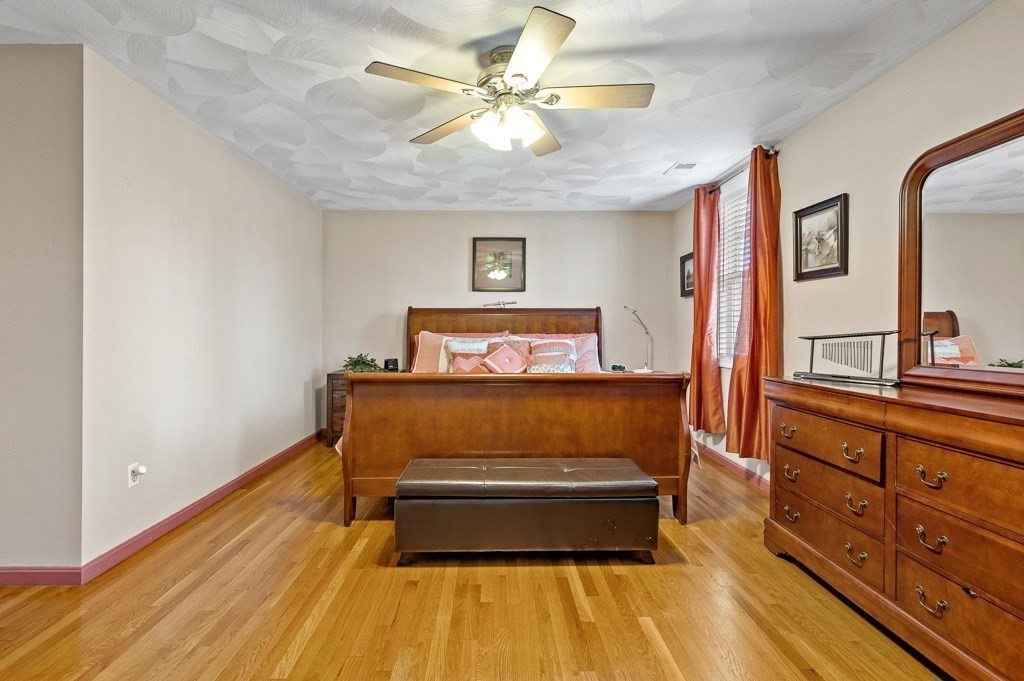 2 Gerry Drive, Unit 2 Hudson, MA 01749 - Photo 18 of 41 a room with wooden floors and ceiling fan