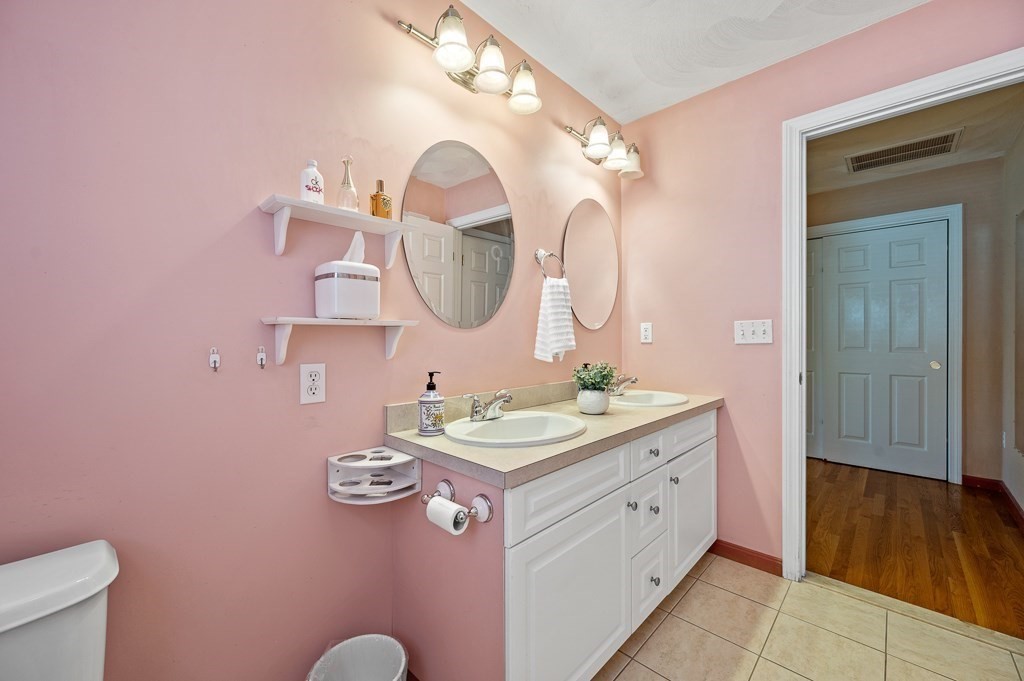2 Gerry Drive, Unit 2 Hudson, MA 01749 - Photo 21 of 41 a en suite bathroom with a double vanity sink and a mirror