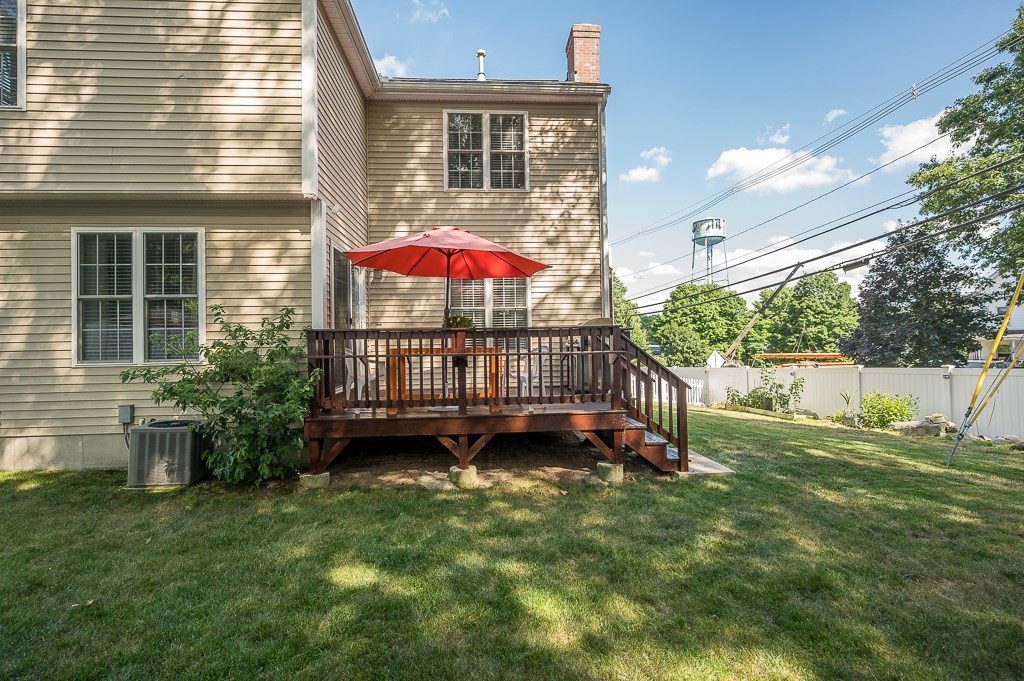 2 Gerry Drive, Unit 2 Hudson, MA 01749 - Photo 31 of 41 a backyard of a house with a yard fire pit and outdoor seating