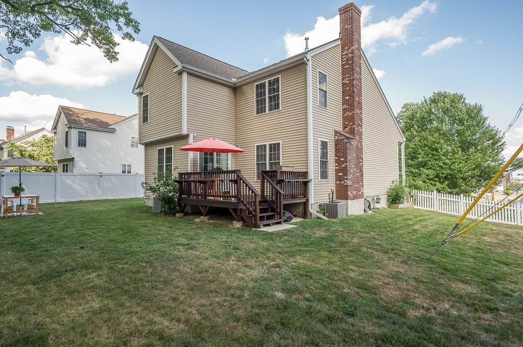 2 Gerry Drive, Unit 2 Hudson, MA 01749 - Photo 33 of 41 a view of a house with a yard and deck