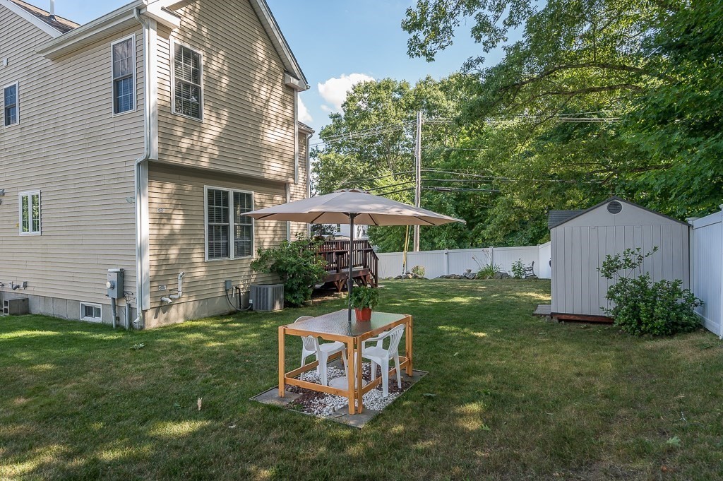 2 Gerry Drive, Unit 2 Hudson, MA 01749 - Photo 34 of 41 a view of a chair and table in backyard of the house