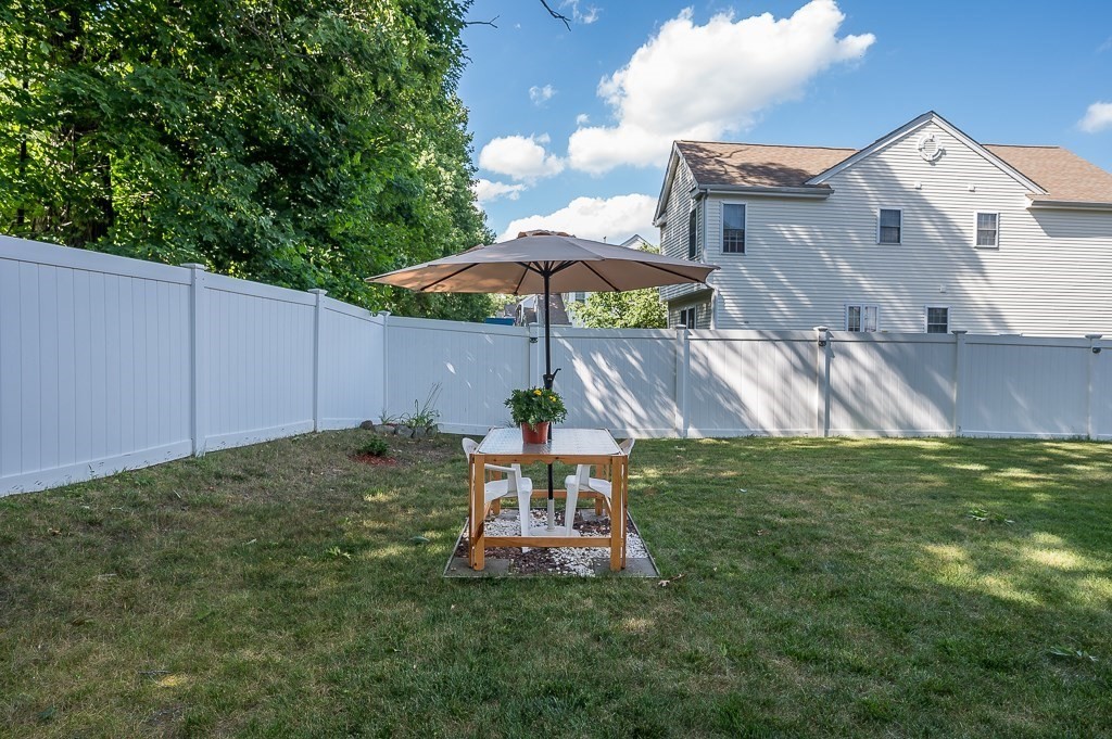 2 Gerry Drive, Unit 2 Hudson, MA 01749 - Photo 37 of 41 a backyard of a house with table and chairs