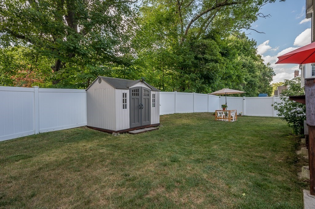 2 Gerry Drive, Unit 2 Hudson, MA 01749 - Photo 38 of 41 a view of a backyard with a garden and fire pit