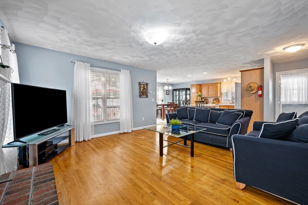 2 Gerry Drive, Unit 2 Hudson, MA 01749 - Photo 6 of 41 a living room with furniture and a flat screen tv