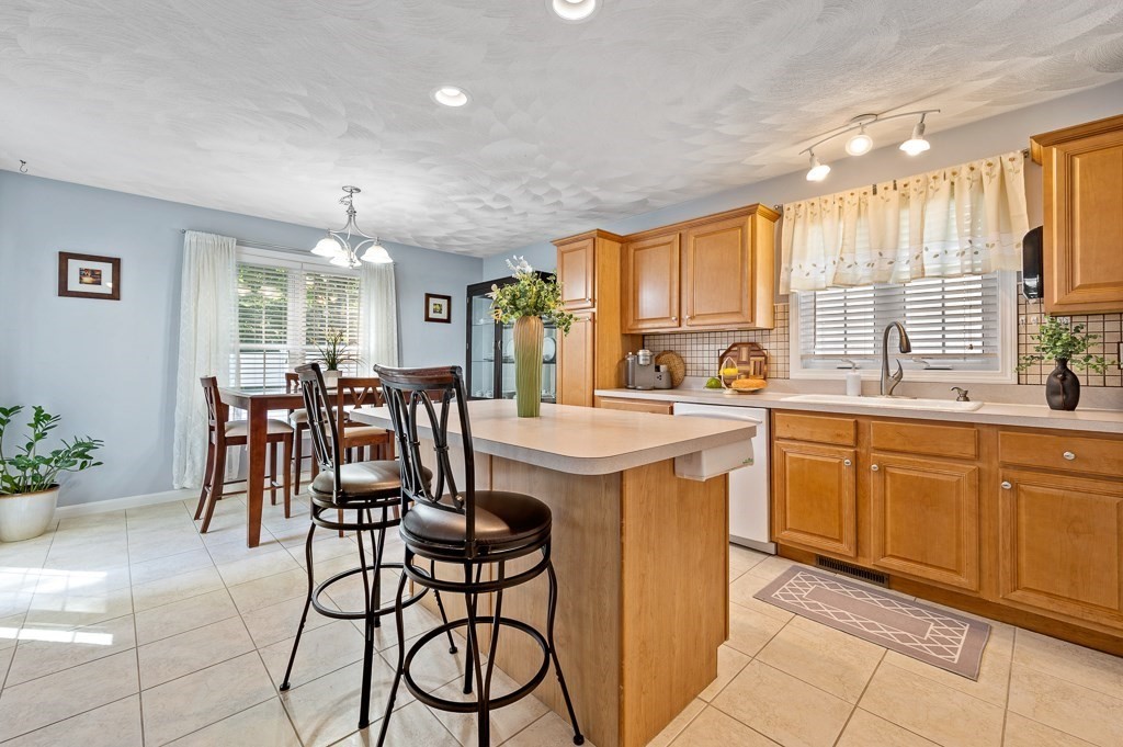 2 Gerry Drive, Unit 2 Hudson, MA 01749 - Photo 10 of 41 a kitchen with stainless steel appliances granite countertop table chairs sink and cabinets