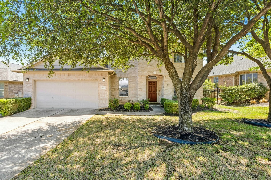 1901 Windberry Path Round Rock, TX 78665 - Photo 1 of 1 a front view of a house with yard and garage