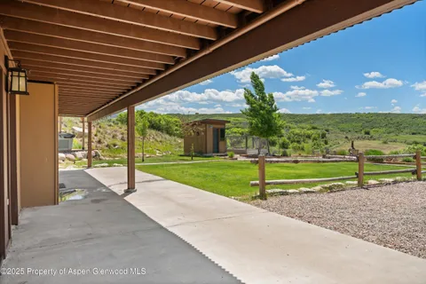 a view of a backyard with sitting area