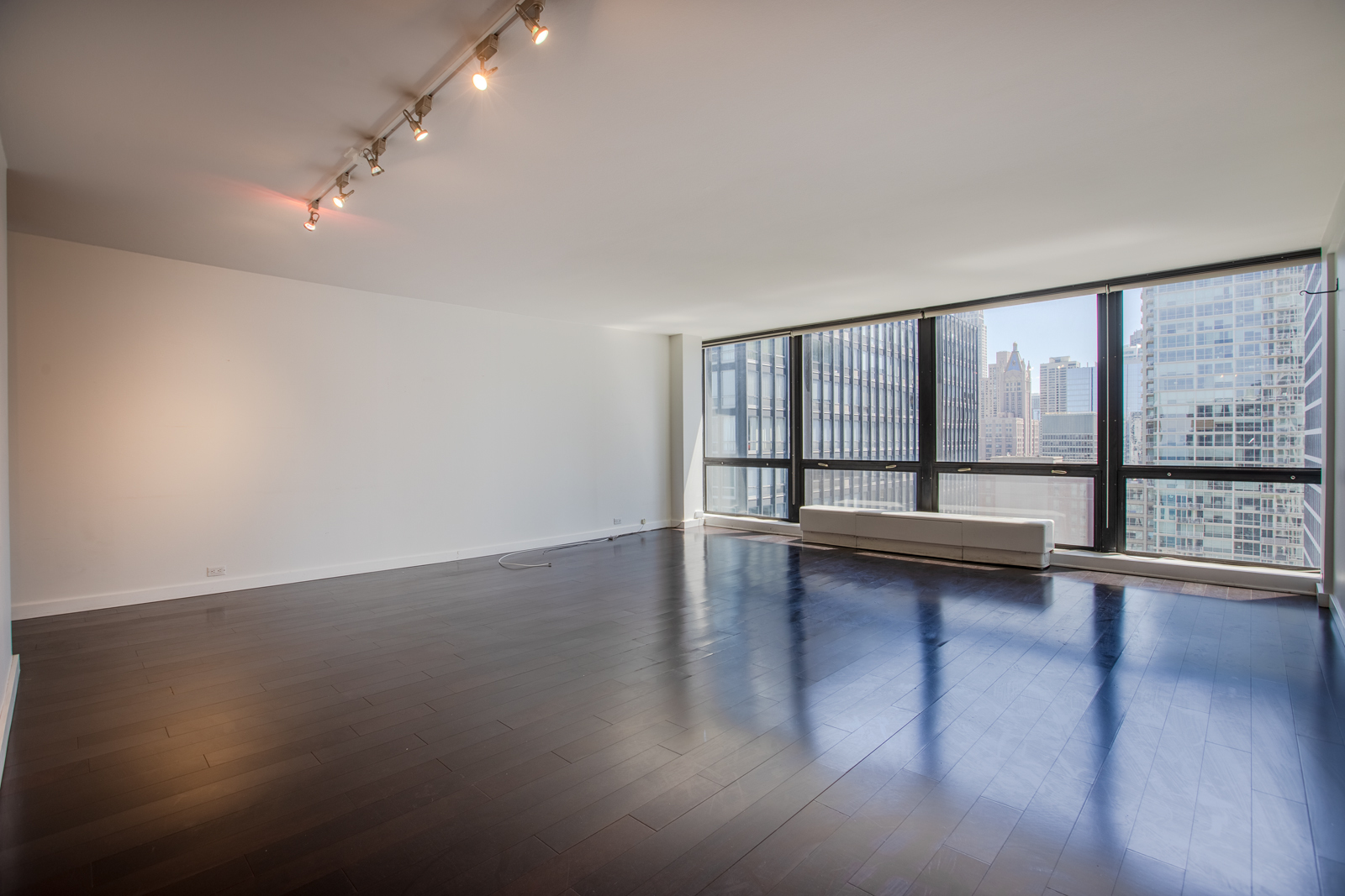 Undisclosed Address Chicago, IL 60611 - Photo 2 of 9 an empty room with wooden floor and windows