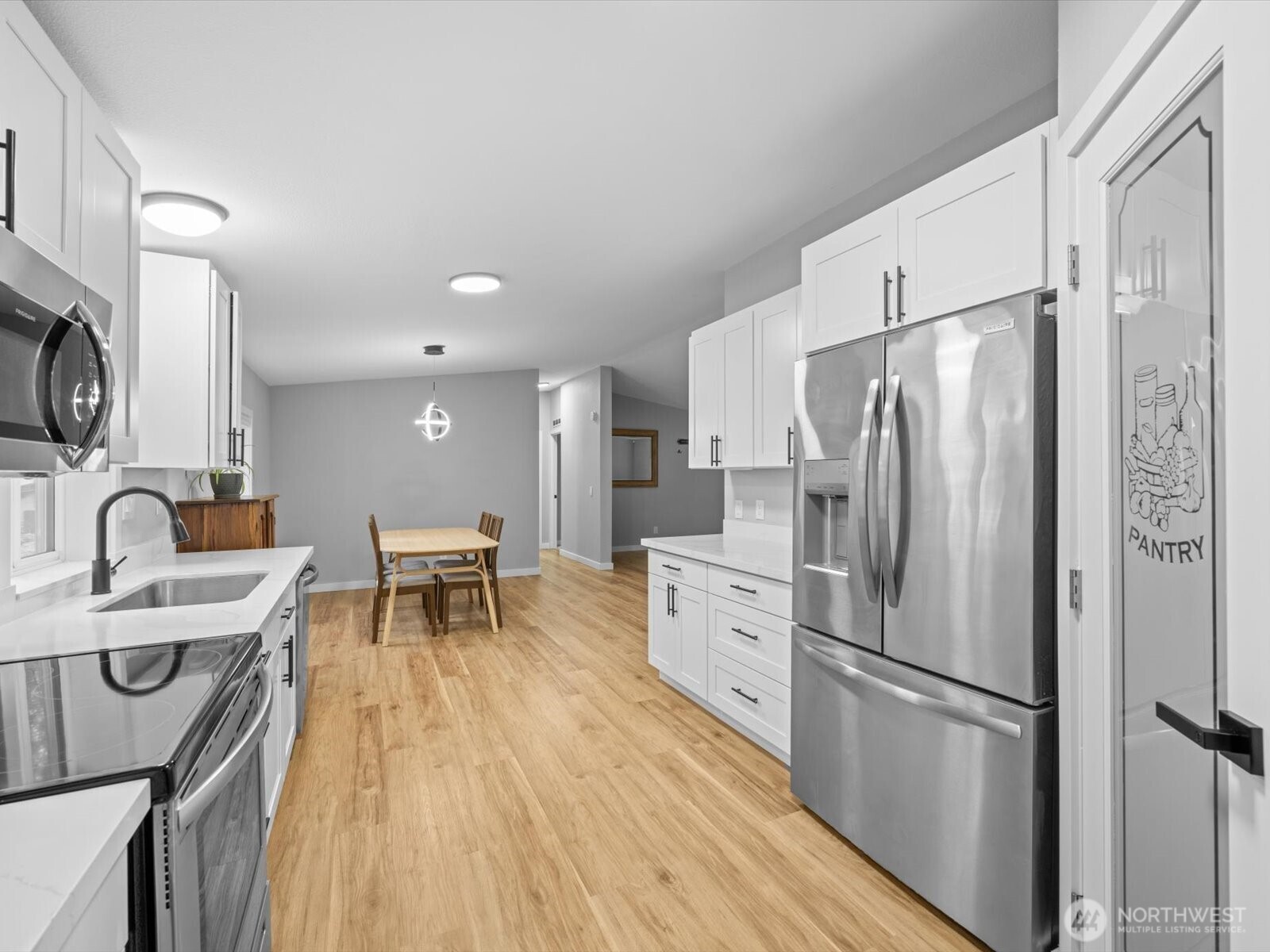 20500 32nd Drive Southeast Bothell, WA 98012 - Photo 14 of 39 a kitchen with stainless steel appliances a refrigerator a stove a sink dishwasher a oven with white cabinets and wooden floor