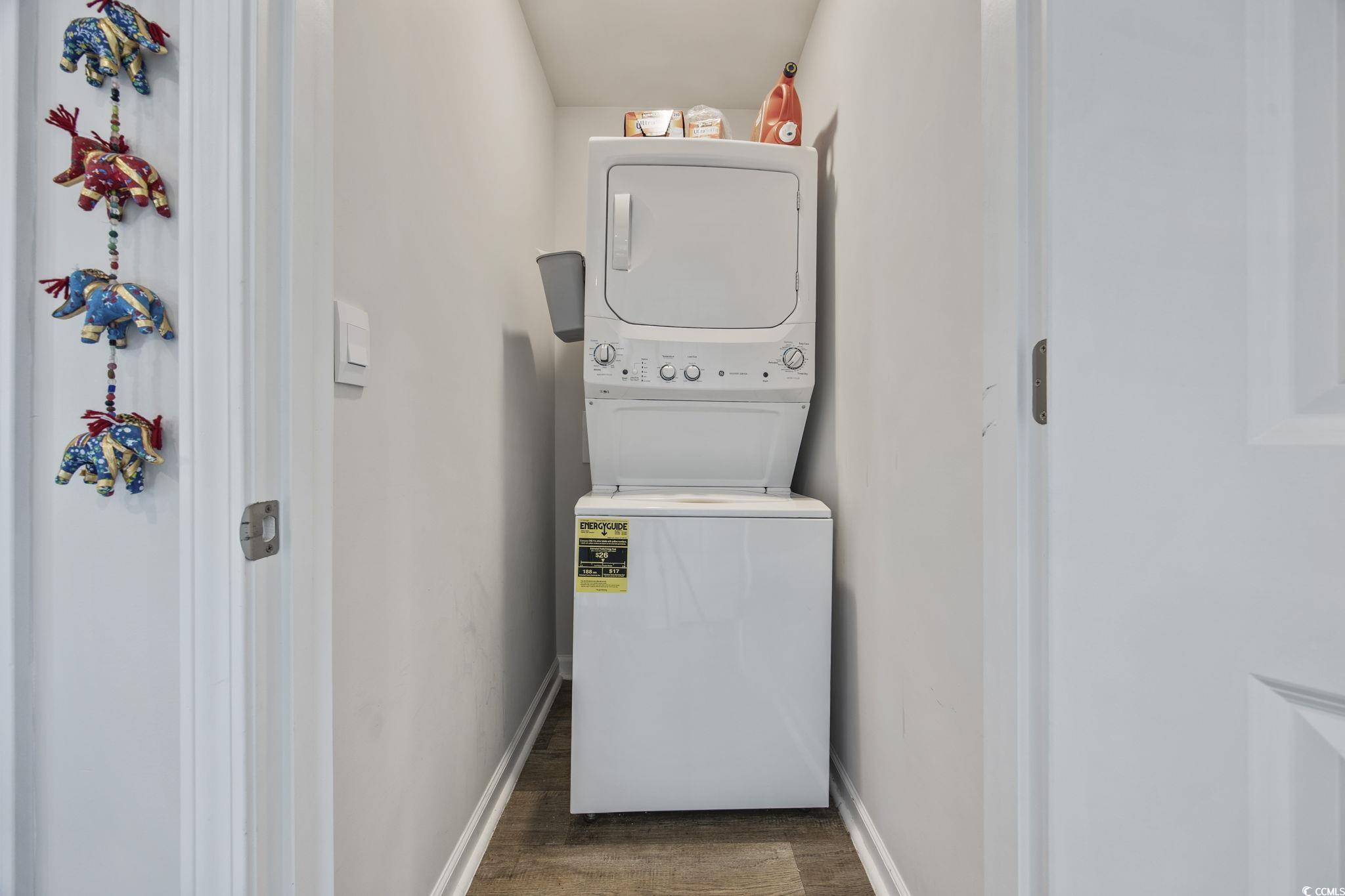 924 Akron Street Conway, SC 29526 - Photo 17 of 37 Washroom with stacked washer and clothes dryer, wood finished floors, and baseboards