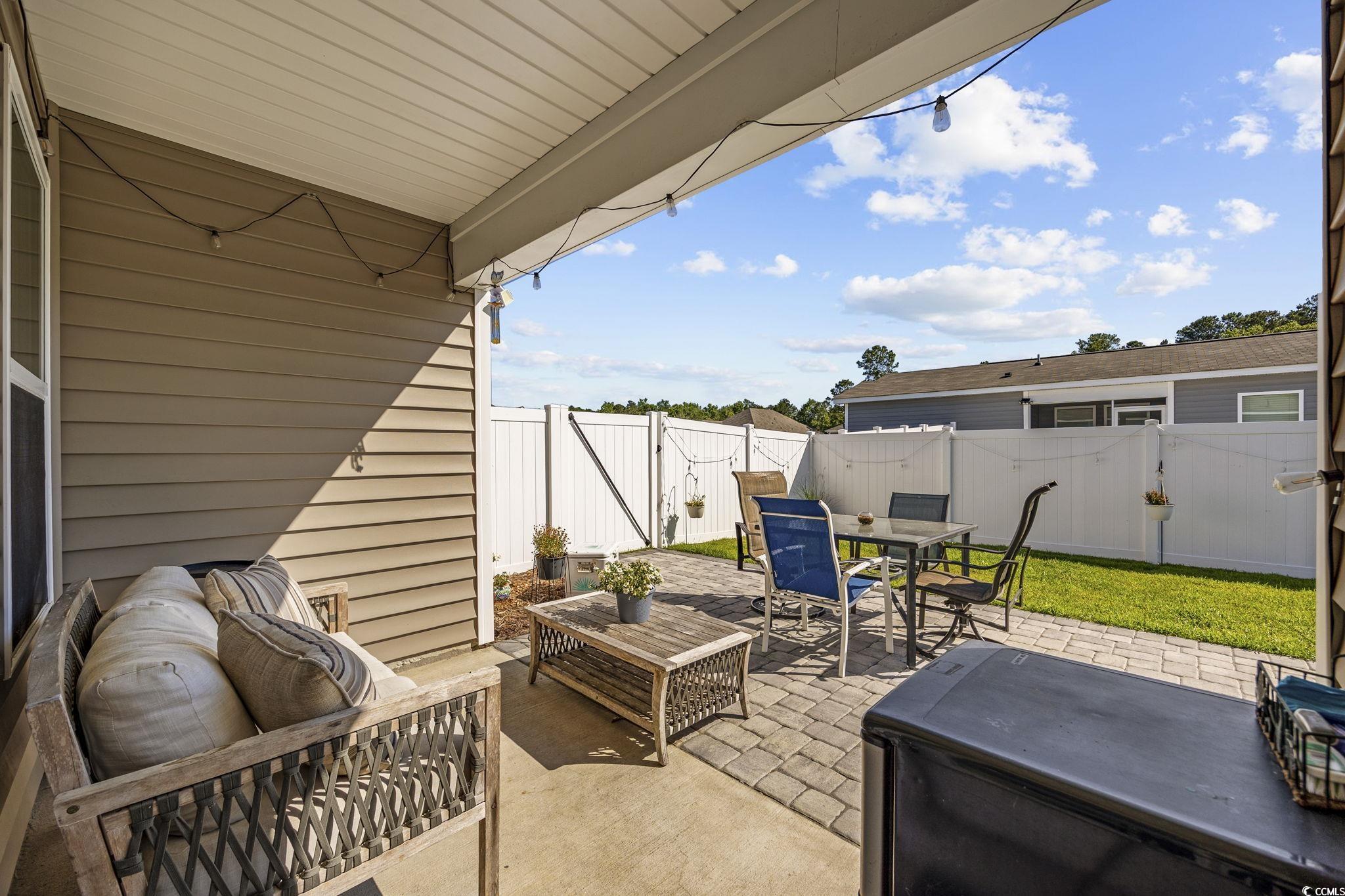 924 Akron Street Conway, SC 29526 - Photo 21 of 37 Fenced backyard with outdoor dining area, a patio area, a gate, and outdoor lounge area