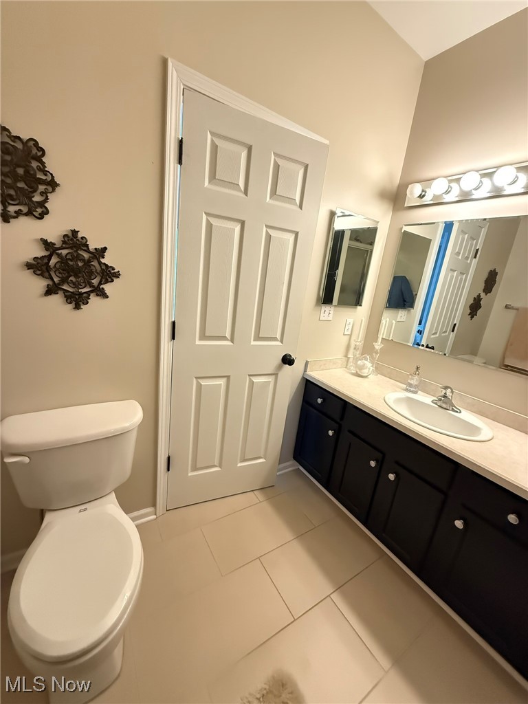 5645 Clingan Road, Unit 2D Struthers, OH 44471 - Photo 34 of 50 Bathroom with tile patterned floors, vanity, toilet, and baseboards