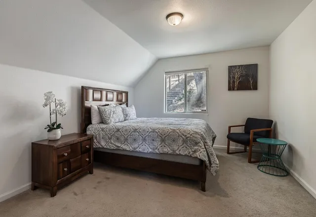 a bedroom with a bed and a furniture