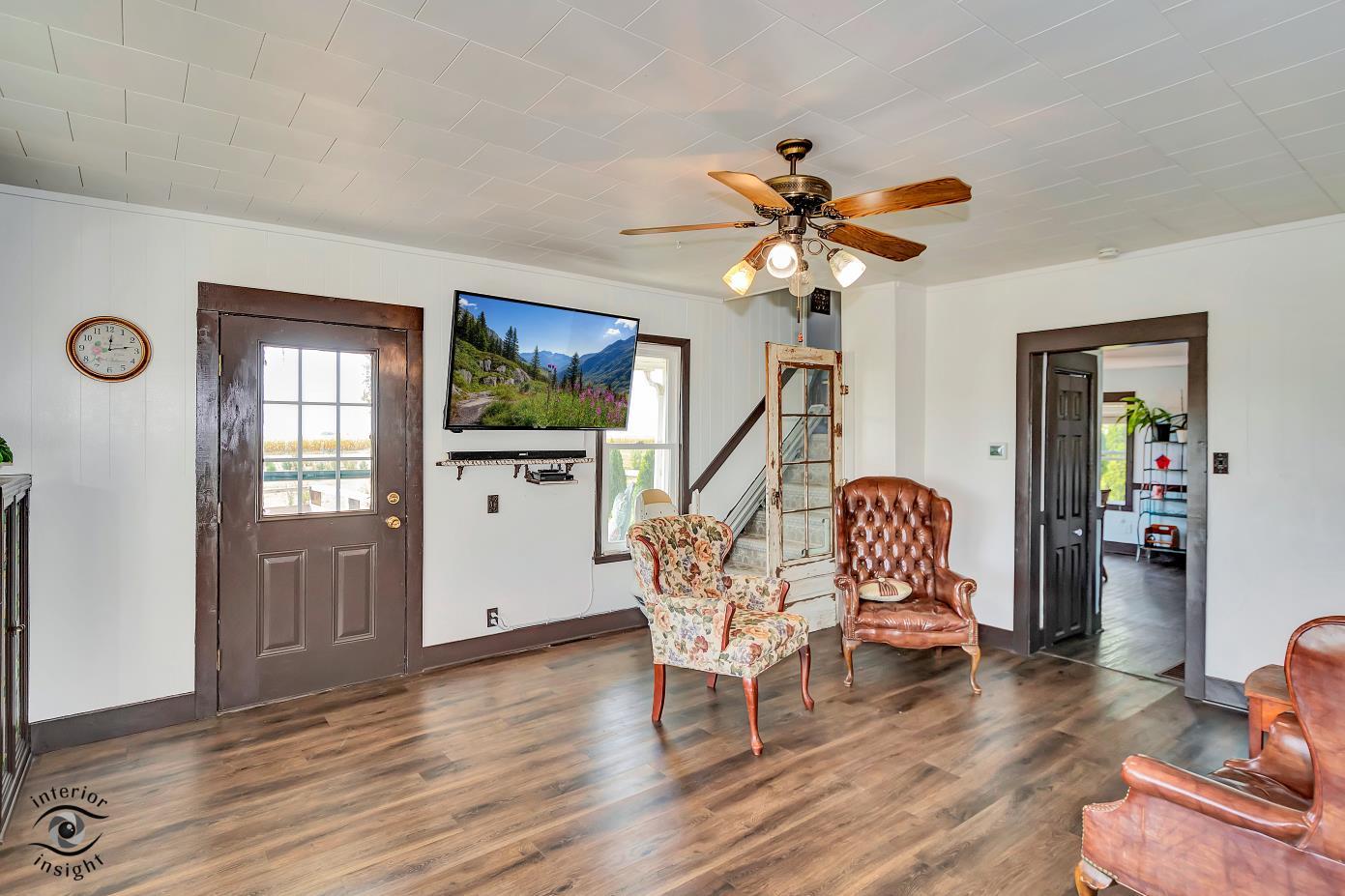 1258 East 2900 North Road Clifton, IL 60927 - Photo 16 of 38 a view of a livingroom with furniture and a chandelier fan
