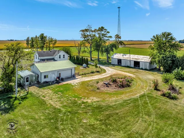 a view of a house with a yard and potted plants
