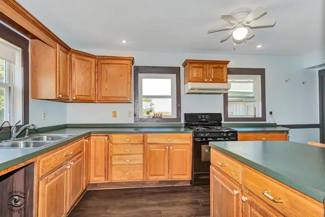 a kitchen with stainless steel appliances granite countertop a stove a sink and a refrigerator