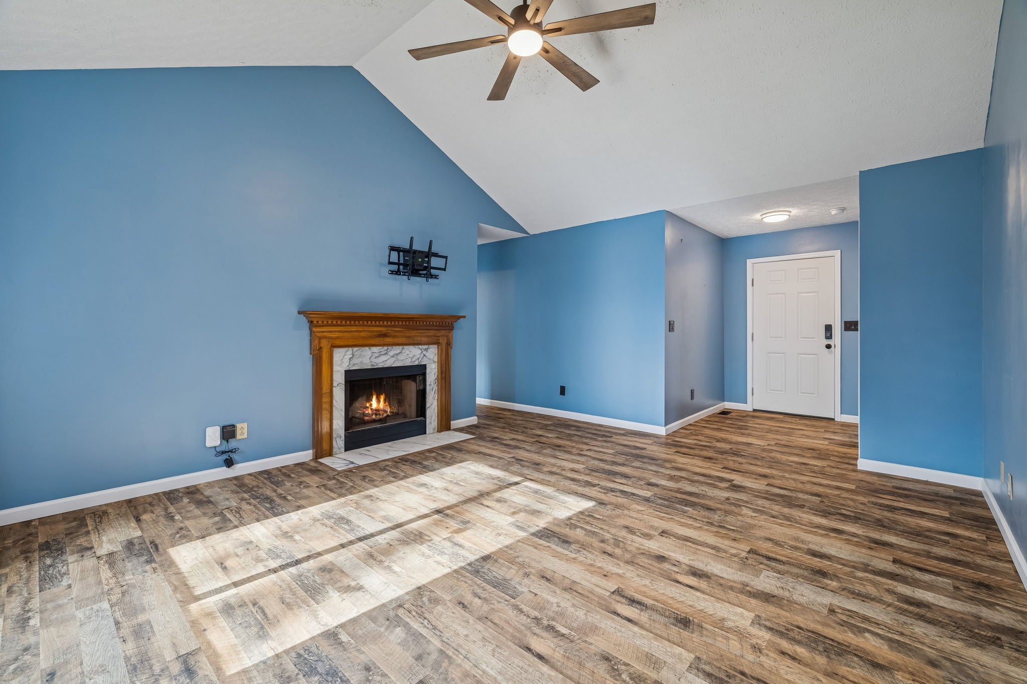 179 West Hester Road Cottontown, TN 37048 - Photo 8 of 43 a view of an empty room with a fireplace and a chandelier fan