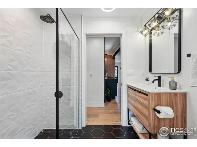 a kitchen with stainless steel appliances kitchen island a table chairs in it and wooden floors