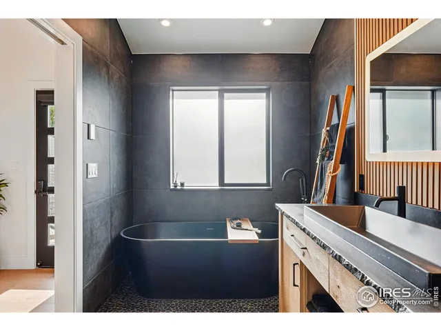 a bathroom with a sink a toilet a shower and a mirror