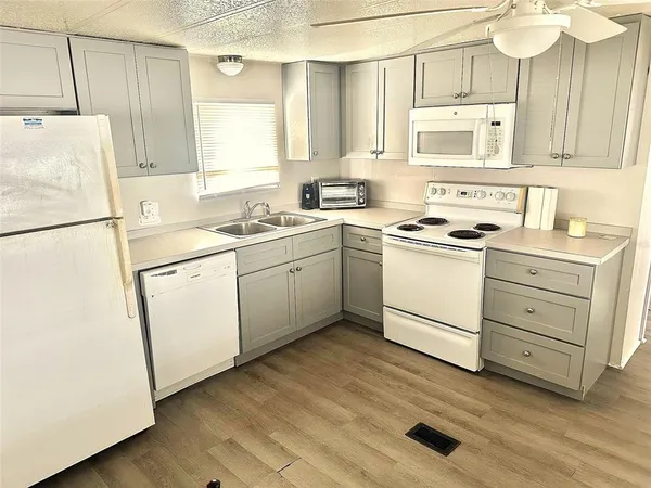 a kitchen with a white cabinets and white appliances