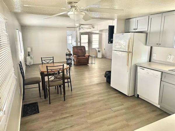 a view of kitchen with furniture and wooden floor