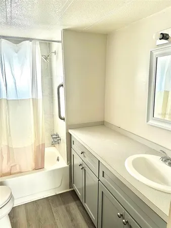 a spacious bathroom with a tub sink and mirror