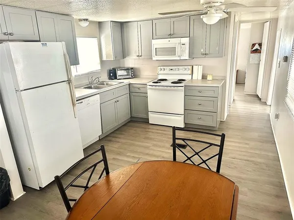 a kitchen with stainless steel appliances a stove a sink cabinets and a refrigerator