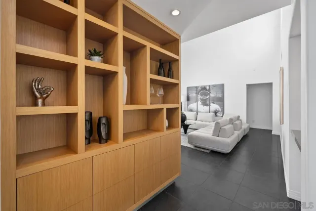 a living room with furniture and a painting on the wall