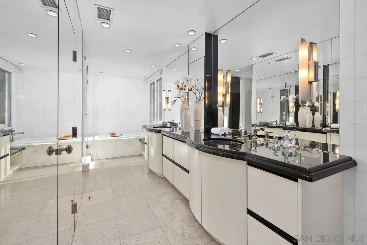 6172 Via Posada Del Norte Rancho Santa Fe, CA 92067 - Photo 16 of 23 a large white bathroom with a double vanity sink a mirror and a bathtub