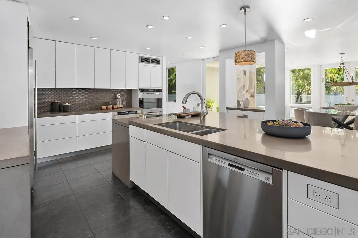 6172 Via Posada Del Norte Rancho Santa Fe, CA 92067 - Photo 5 of 23 a kitchen with stainless steel appliances granite countertop a sink a stove and a refrigerator