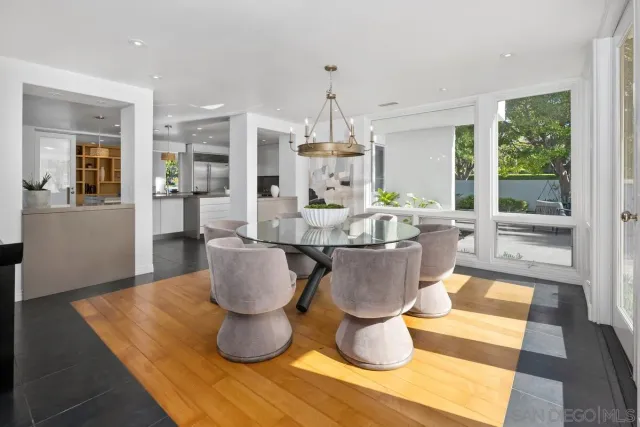 a dining room with table or chandelier and a rug
