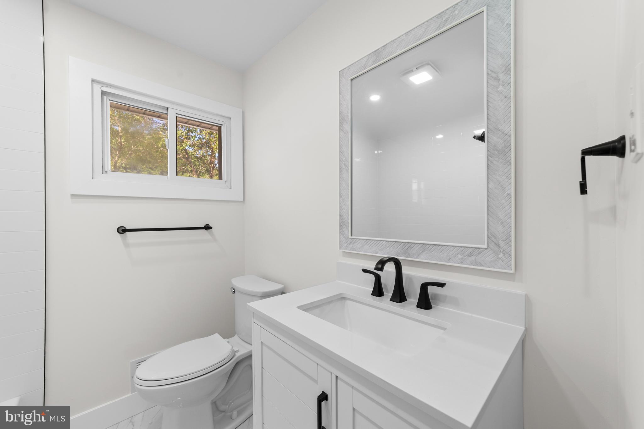 100 Colwick Drive Somers Point, NJ 08244 - Photo 13 of 30 a bathroom with a sink a toilet and mirror