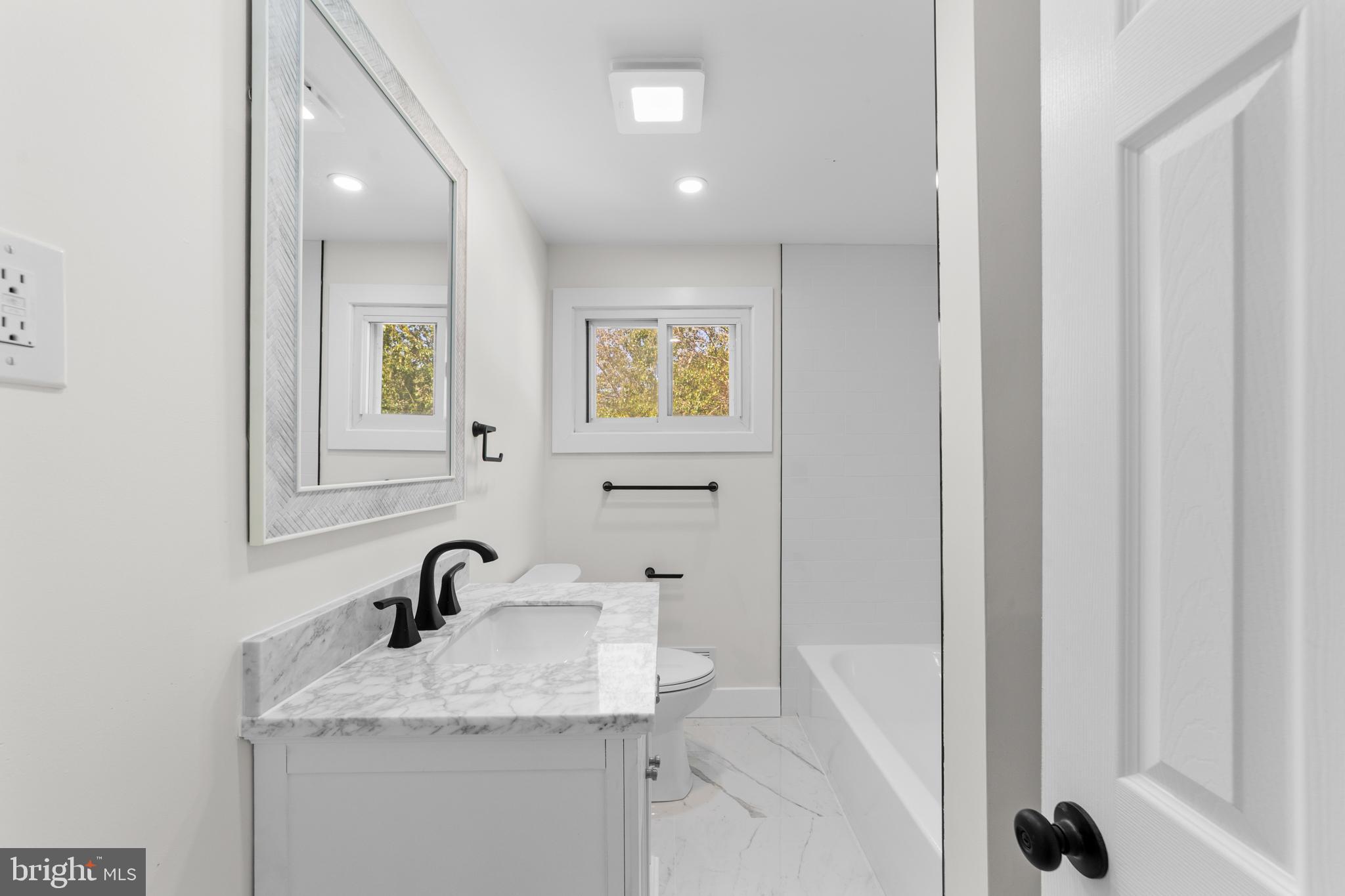 100 Colwick Drive Somers Point, NJ 08244 - Photo 23 of 30 a bathroom with a granite countertop sink and a mirror