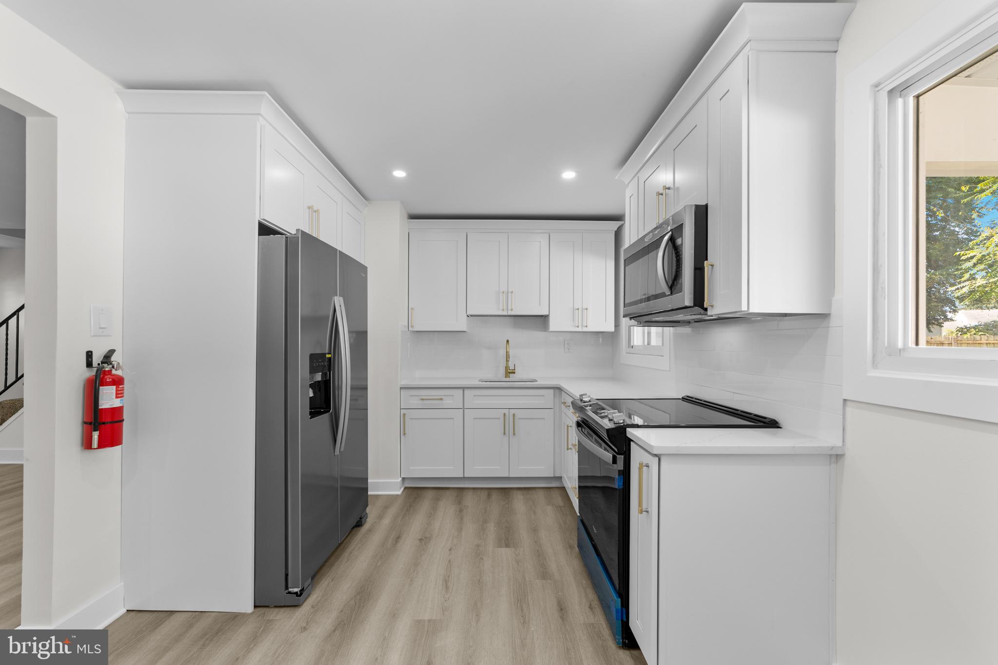 100 Colwick Drive Somers Point, NJ 08244 - Photo 3 of 30 a kitchen with stainless steel appliances granite countertop a refrigerator sink and stove