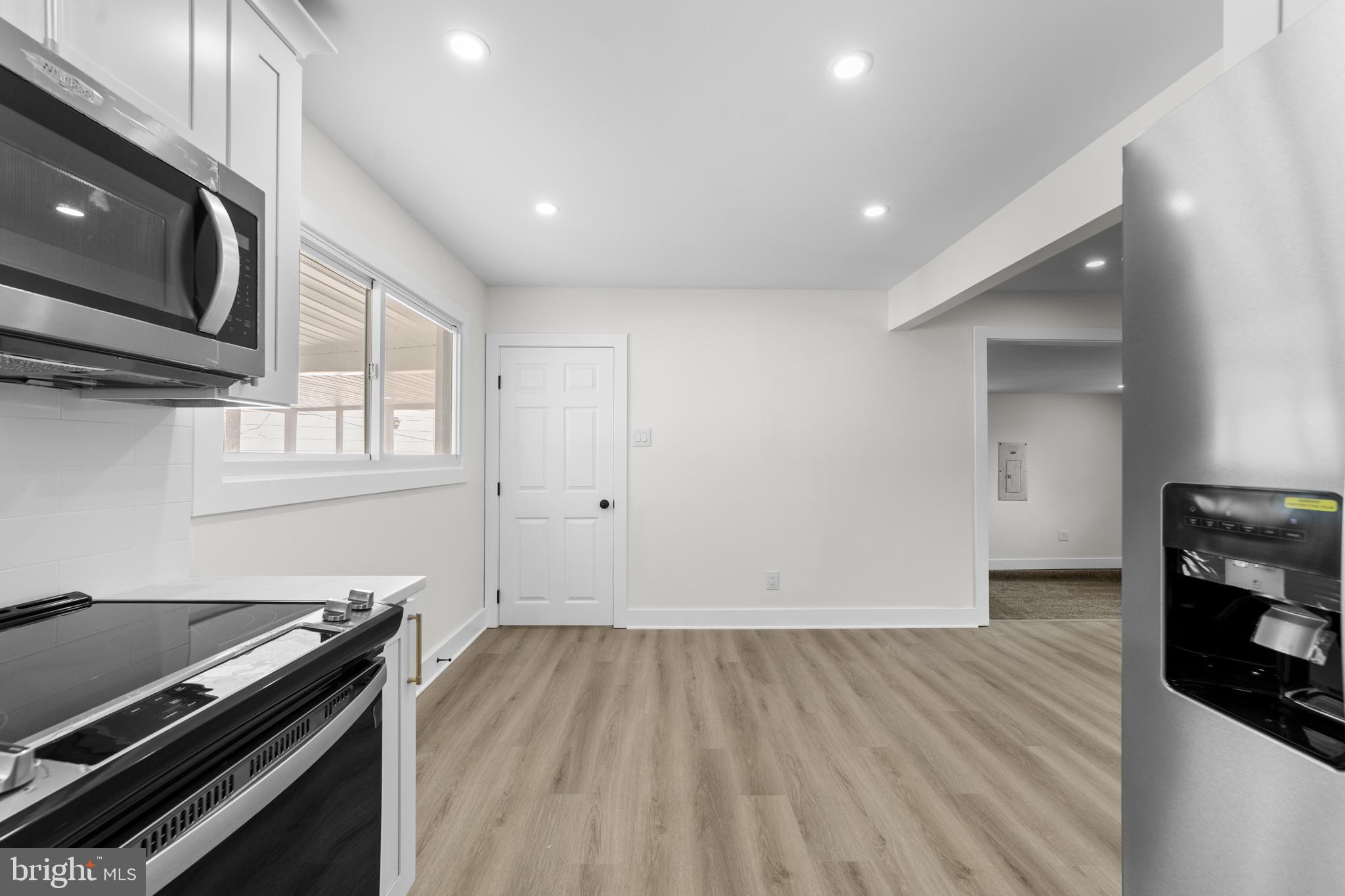 100 Colwick Drive Somers Point, NJ 08244 - Photo 5 of 30 a kitchen with wooden floor and a stove top oven