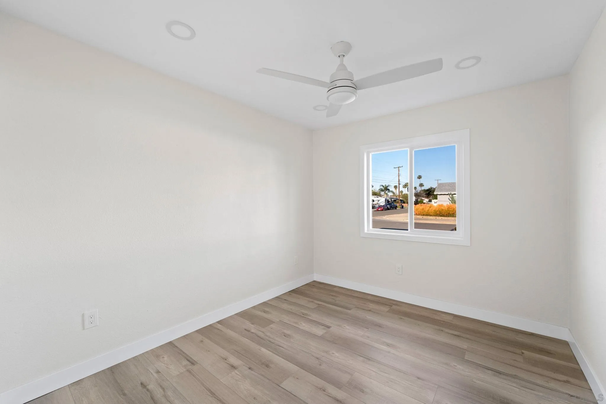 9511 Nicole Way Santee, CA 92071 - Photo 17 of 27 an empty room with wooden floor ceiling fan and window