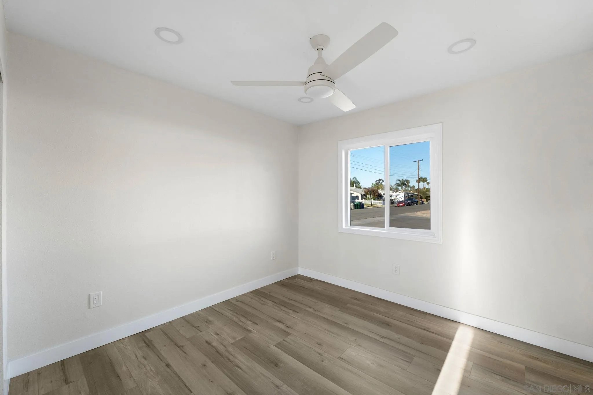9511 Nicole Way Santee, CA 92071 - Photo 21 of 27 an empty room with wooden floor ceiling fan and windows