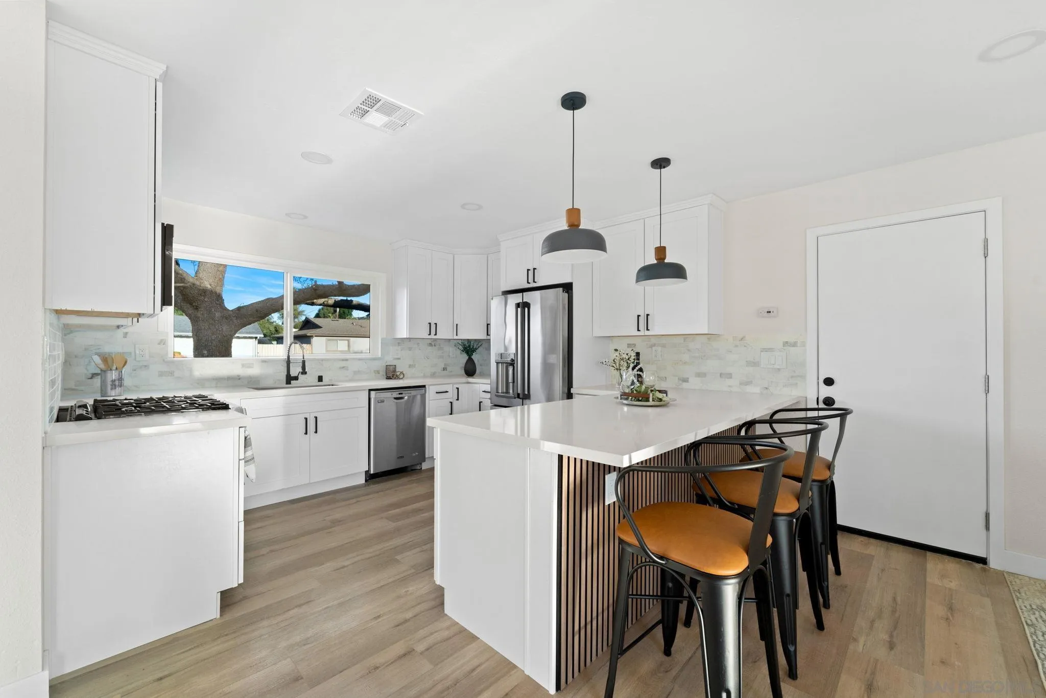 9511 Nicole Way Santee, CA 92071 - Photo 6 of 27 a kitchen with a sink cabinets and wooden floor