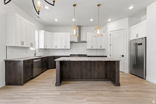 2862 South Mountain Rnch Road Cedar City, UT 84720 - Photo 12 of 64 Modern kitchen featuring a two-toned cabinetry design, stainless steel appliances, and wood-finish flooring