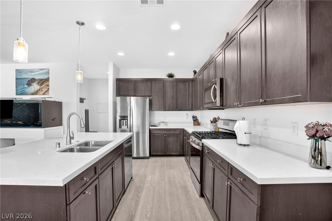 6281 Angora Peak Lane Las Vegas, NV 89115 - Photo 14 of 34 Culinary creations come to life in this contemporary kitchen, featuring ample counter space and sophisticated cabinetry.