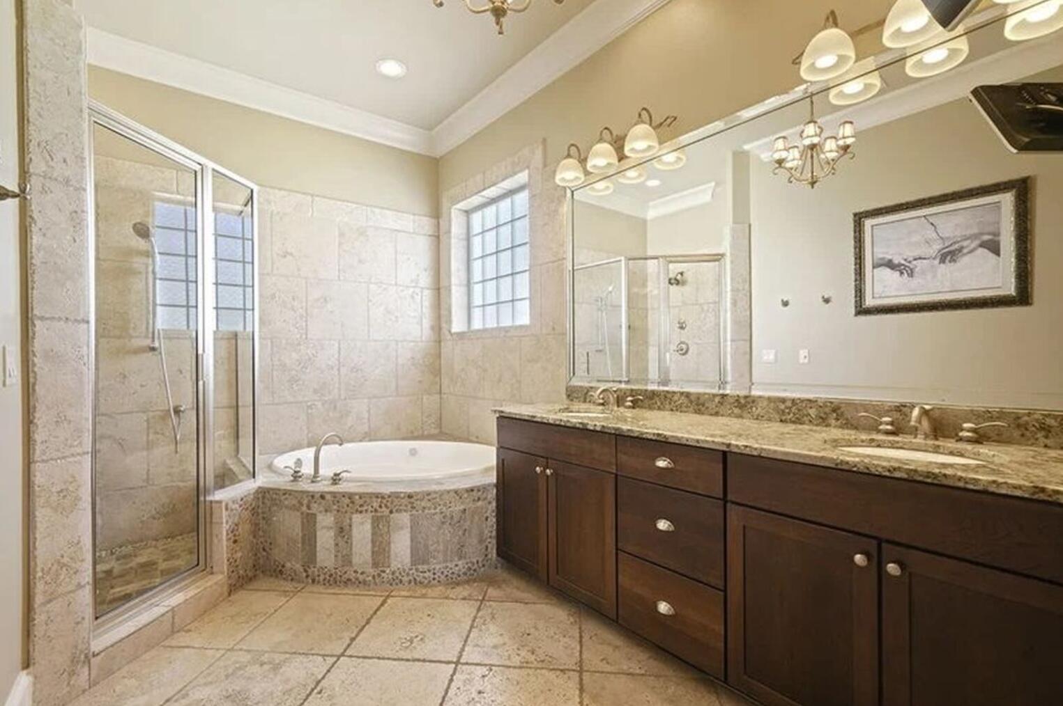 4836 Ocean Boulevard Destin, FL 32541 - Photo 11 of 44 a bathroom with a granite countertop sink a large mirror and a bathtub