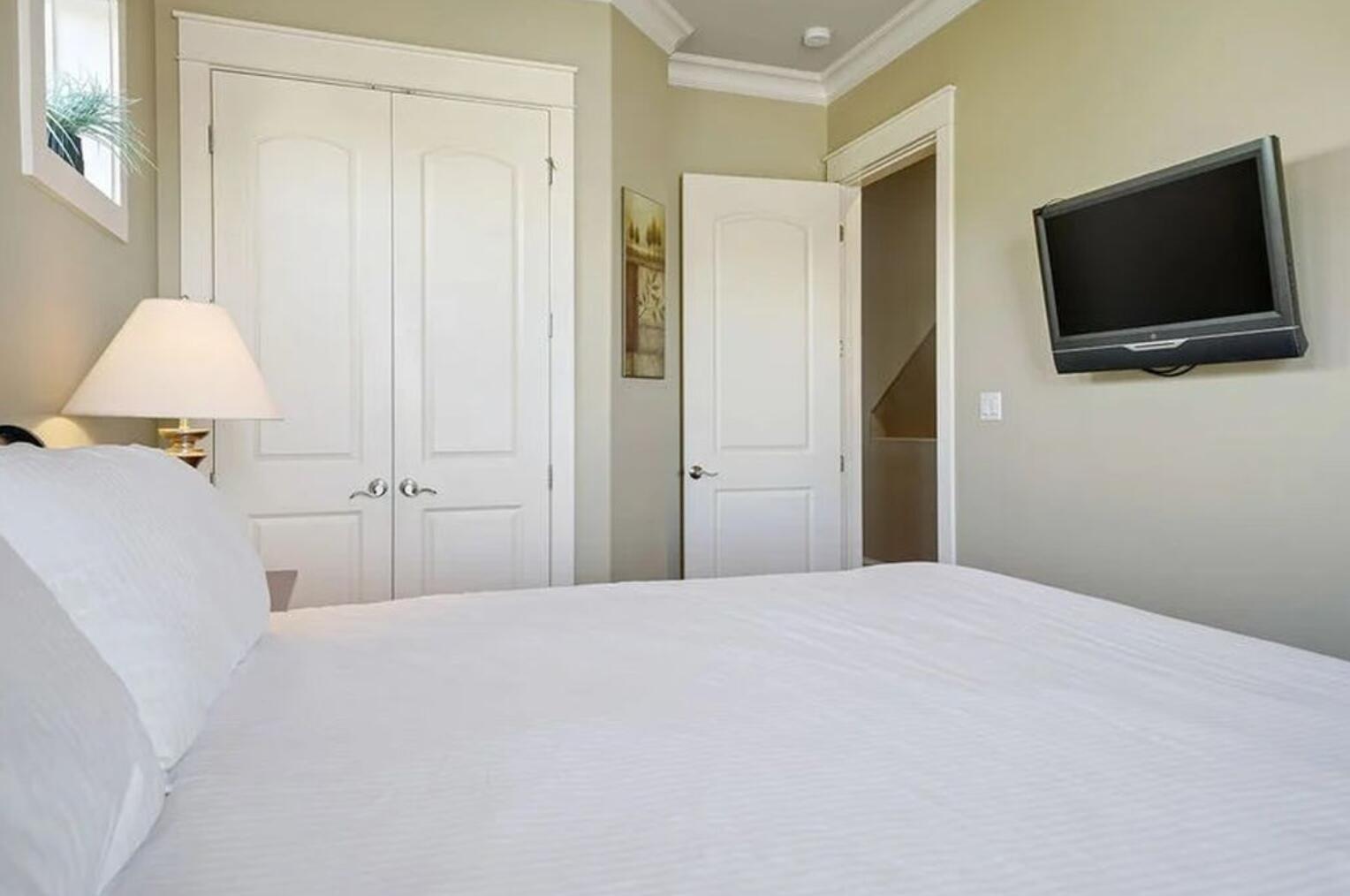 4836 Ocean Boulevard Destin, FL 32541 - Photo 20 of 44 a bedroom with a bed and a flat screen tv