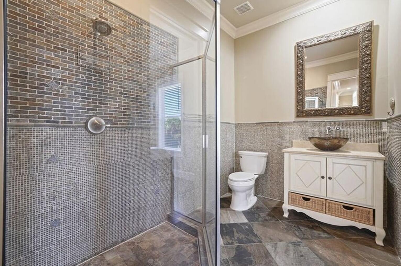 4836 Ocean Boulevard Destin, FL 32541 - Photo 21 of 44 a bathroom with a toilet a sink and shower