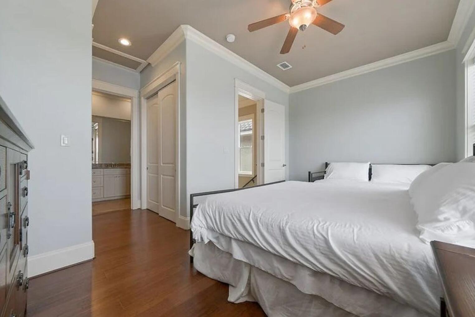 4836 Ocean Boulevard Destin, FL 32541 - Photo 23 of 44 a bedroom with a bed and a chandelier