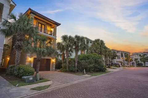 a view of a swimming pool with outdoor seating and plants